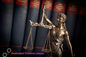 “Dedicated criminal lawyer concept with Lady Justice statue in front of law books – strong defense representation.”