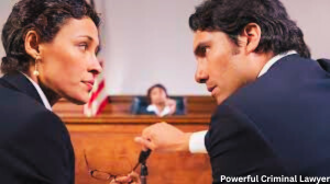 Two powerful criminal lawyers in a courtroom quietly discussing strategy near the judge’s bench, symbolizing strong legal defense and professional representation.