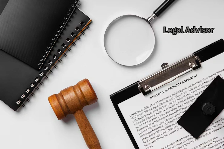 Legal advisor workspace with gavel, magnifying glass, clipboard holding intellectual property agreement, and legal documents on a desk